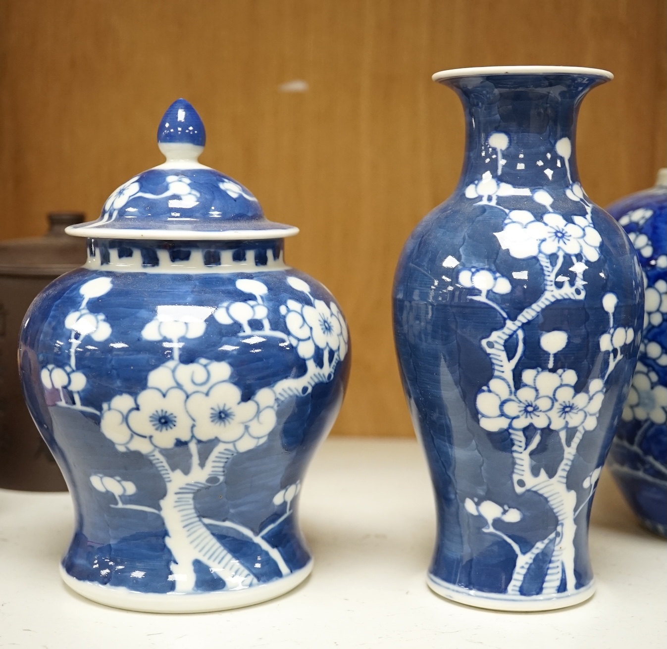 Two Chinese prunus jars and two vases, early 20th century, tallest 26cm, together with two Chinese Yixing pottery teapots, one Republic period, tallest 12.5cm. Condition - varies, poor to fair